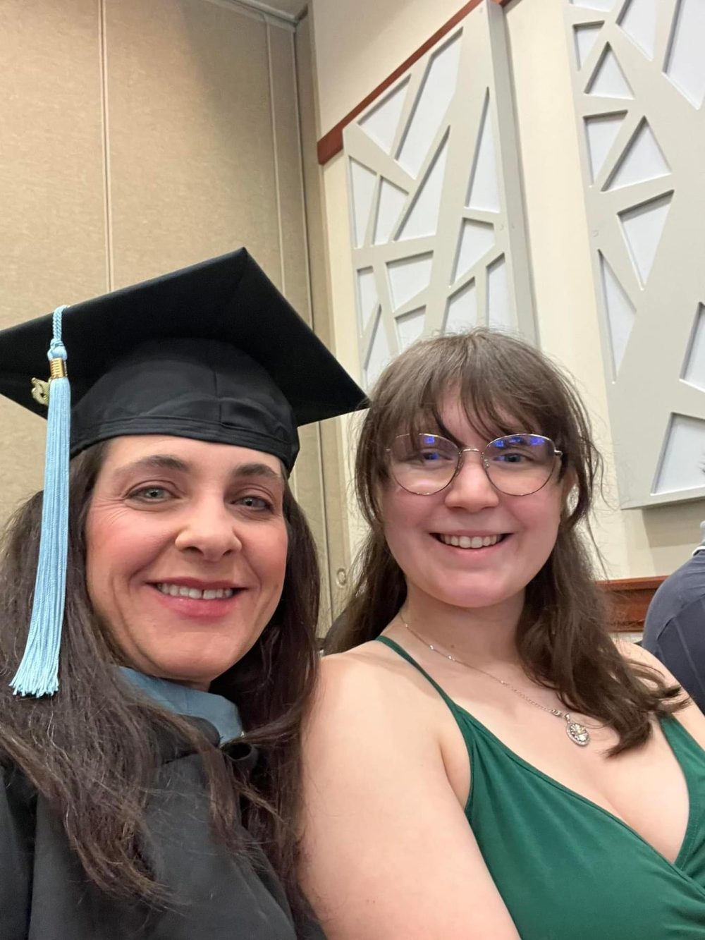 Jennifer Merry and her daughter Jeana, now an adult, sit next to each other celebrating Jennifer's MSA graduation